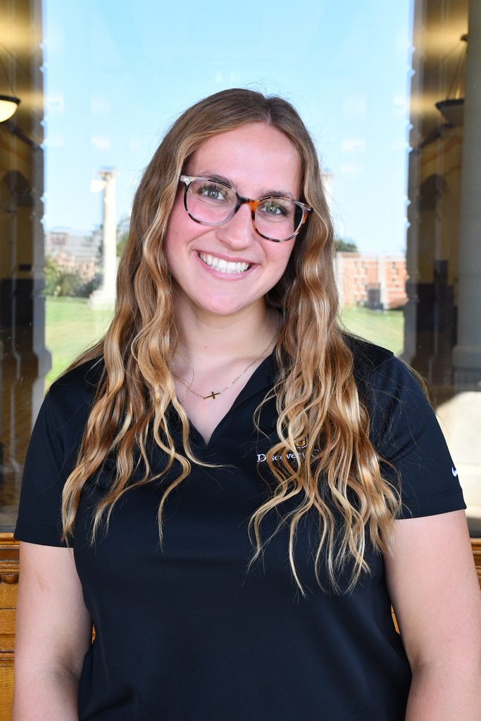 Headshot of Hannah Wenzel, a peer advisor at the University of Missouri, smiling in a black polo shirt.